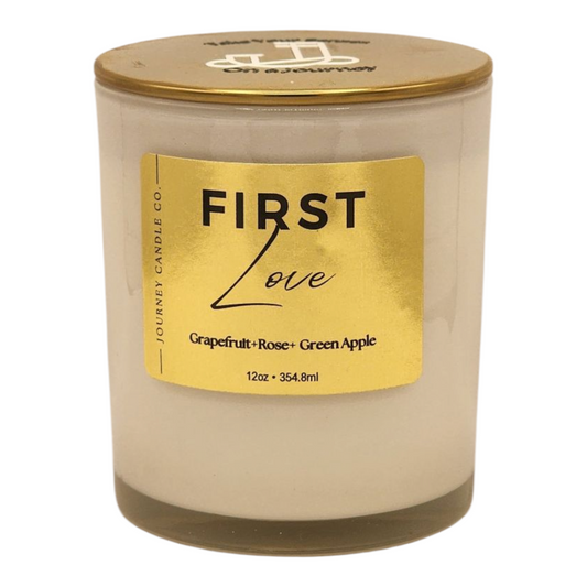 First Love 12 oz soy candle by Journey Candle Co. – a bright, romantic blend of grapefruit, green apple, and soft rose in a white jar with gold lid.