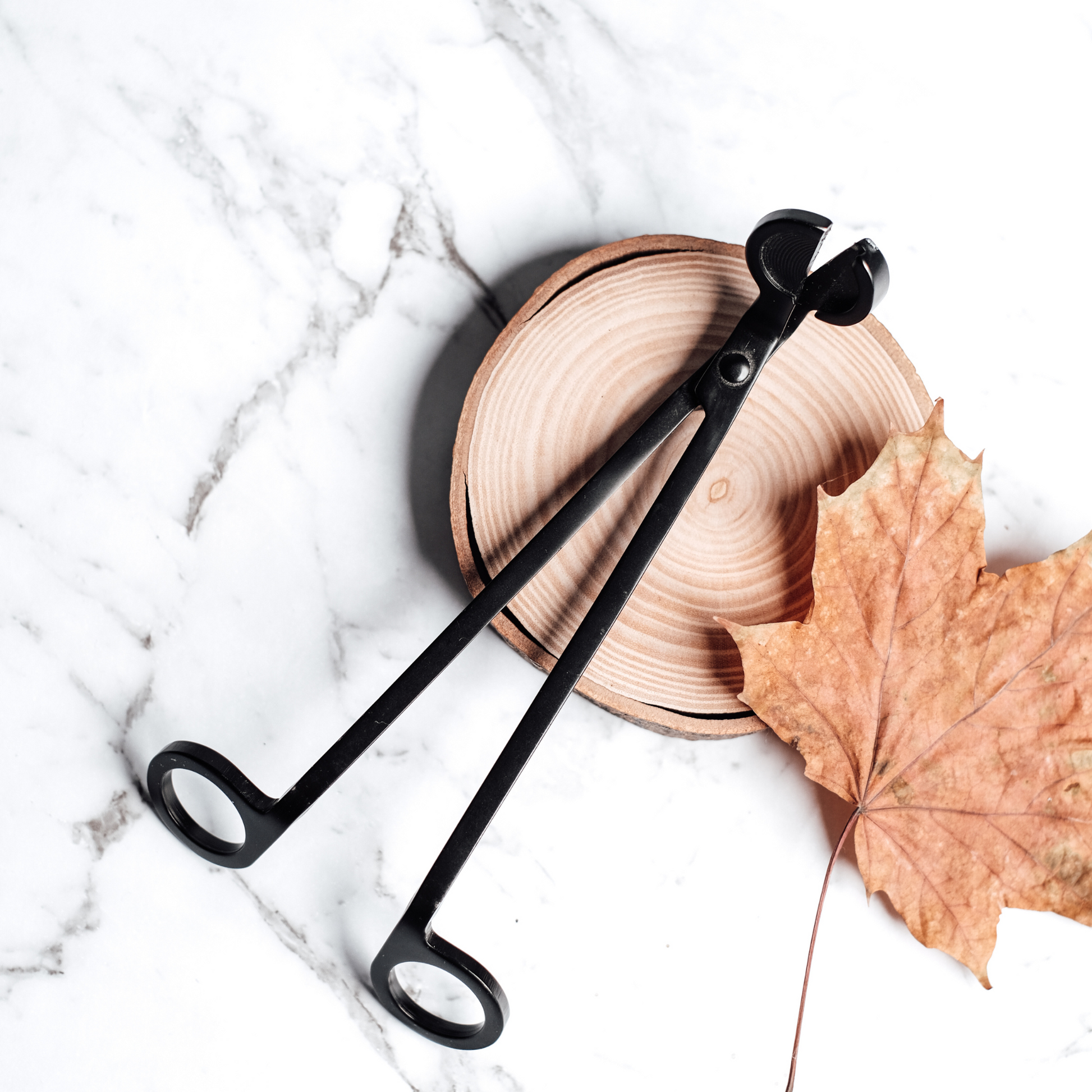 Matte black wick trimmer for candles – sleek design for clean, even burns and a polished candle care routine.