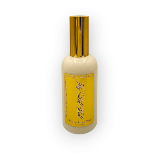 Solid Rock room and linen spray by Journey Candle Co. – bold blend of violet, smooth sandalwood, and earthy tobacco leaf in a 3 oz spray bottle with gold cap.