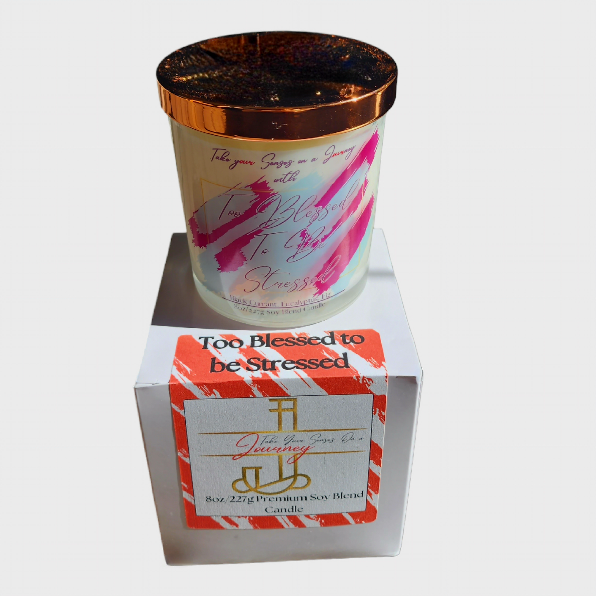 Elegant 8 oz candle in a glass jar with gold lid and custom gift box. Infused with black currant, eucalyptus, and fig for a calming, luxe aroma.